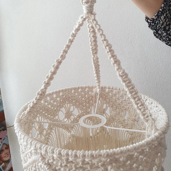 Gros plan sur les détails du tissage en macramé de l'abat-jour à franges.