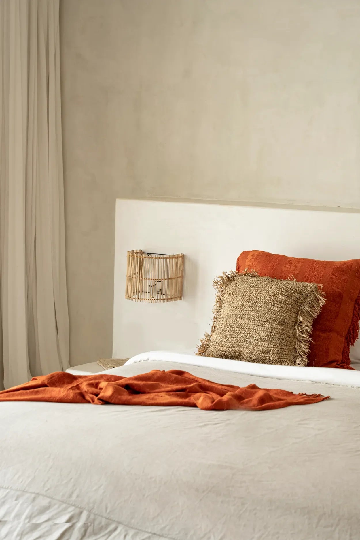 Applique murale en rotin naturel demi-cylindre 25 cm dans une chambre neutre avec accents texturés