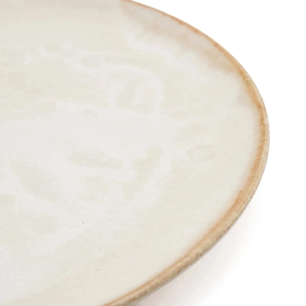 Assiette en grès blanc cassé, bord doré artisanal, texture subtile