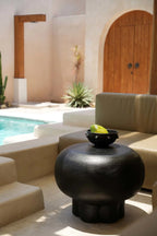 Table basse en céramique noire mate, corps bombé et base évasée