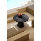 Table d’extérieur ronde en terre cuite brûlée noire finition irisée avec bol de fruits