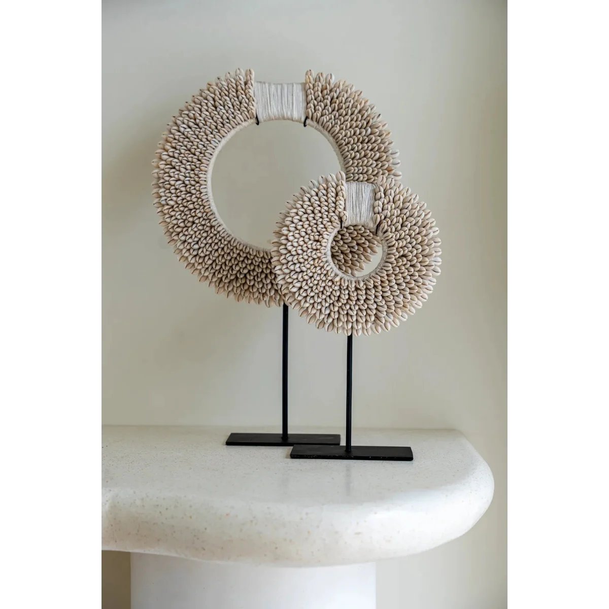 Deux bagues décoratives en coquillages blancs sur socle en métal noir H45 cm