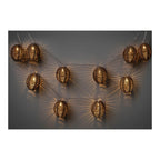 Guirlande lumineuse en rotin naturel avec lanternes ovales ajourées dorées et ampoules chaleureuses