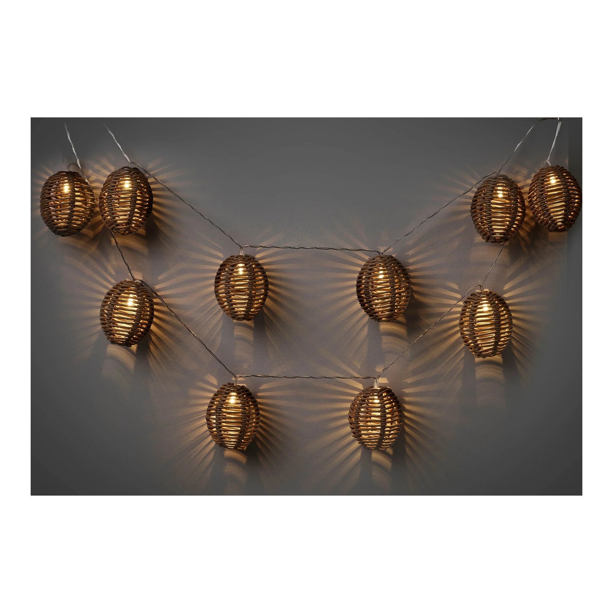 Guirlande lumineuse en rotin naturel avec lanternes ovales ajourées dorées et ampoules chaleureuses