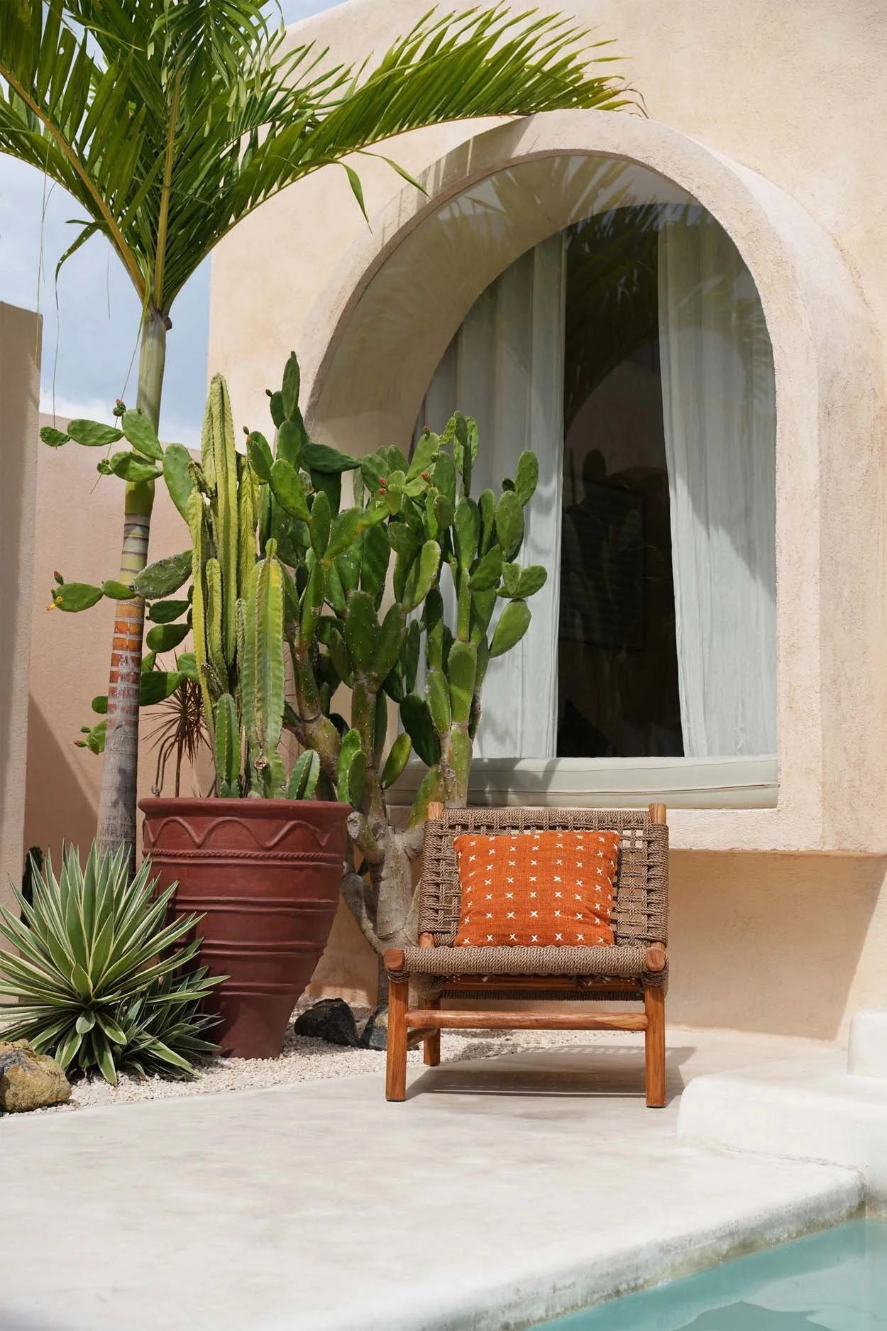 Chaise en bois avec coussin brodé en coton terracotta motif croix blanches