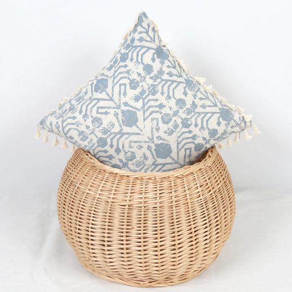 Housse de coussin bleu géométrique sur un panier