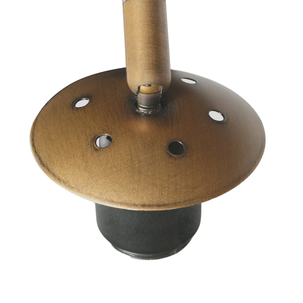 Disque en métal bronze avec trous, attaché à un cylindre, sur une base noire