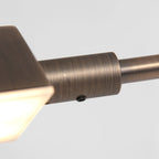 Applique métallique en bronze brossé avec ampoule visible et bras articulé orientable