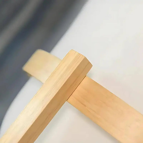 Détail du support en bois clair d'une lampe à pied.