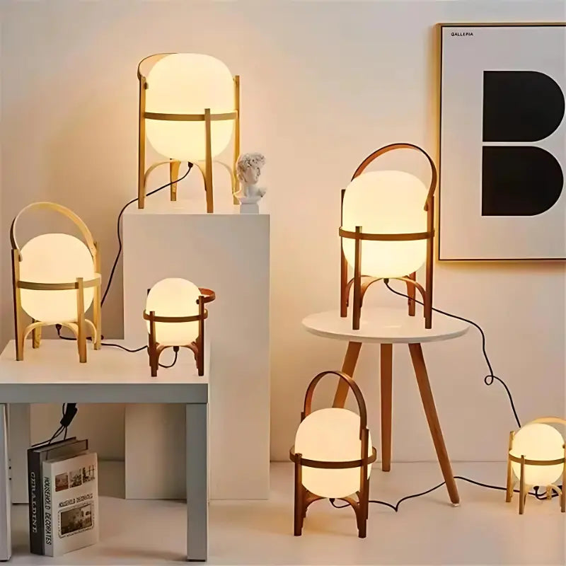 Collection de lampes à pied en bois clair et sombre de différentes tailles sur une table.