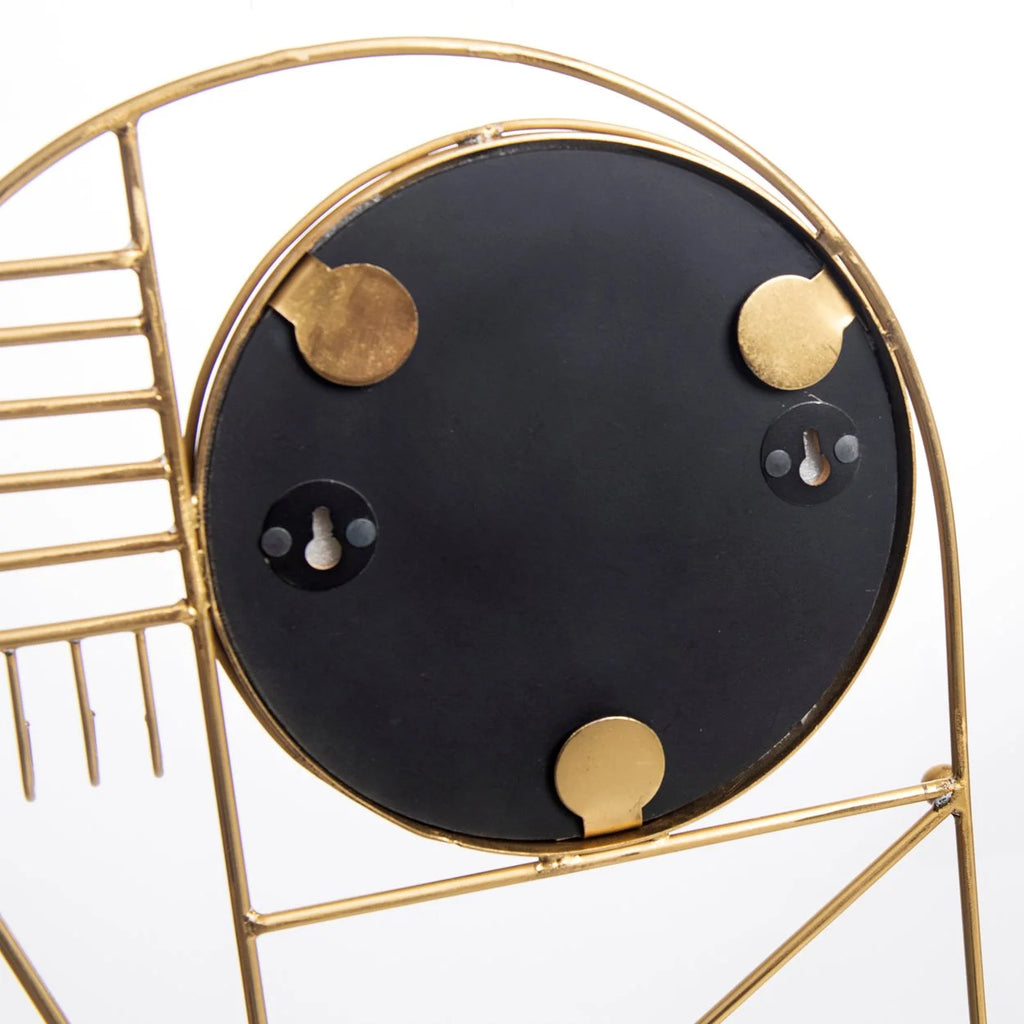 Dos d’un miroir rond noir avec cadre en or et crochets en métal, pour décoration murale