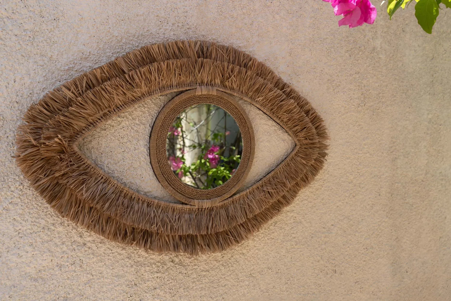 Miroir mural en raphia forme œil 70x40 cm