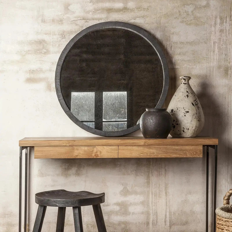 Miroir rond en bois noir 80 cm installé au-dessus d’une console en bois, dans un intérieur moderne et élégant.