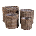 Ensemble de quatre paniers ronds en rotin tressé brun grisé avec doublure plastique