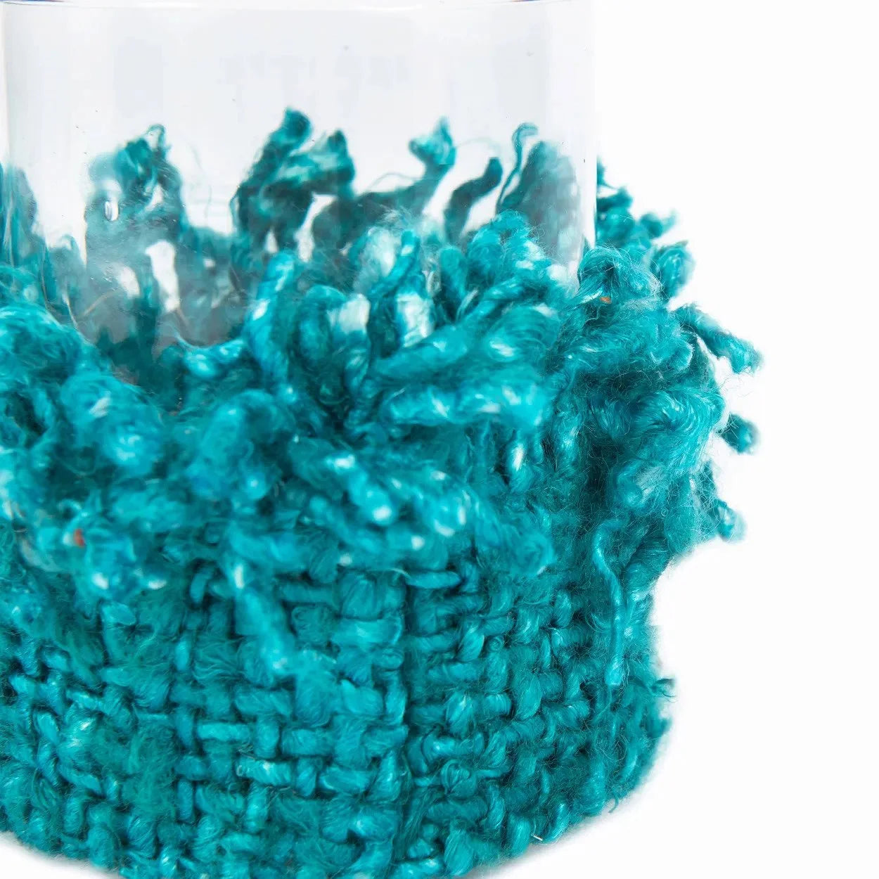 Photophore en verre turquoise avec un cosy tissé teal à franges textile
