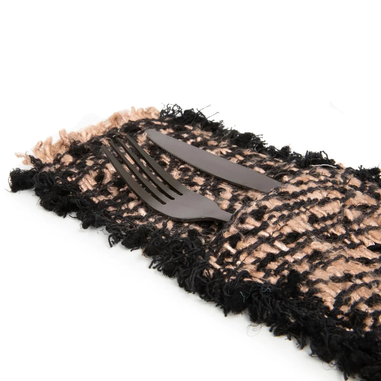 Four black flatware in fringed cotton woven holder for stylish table setting