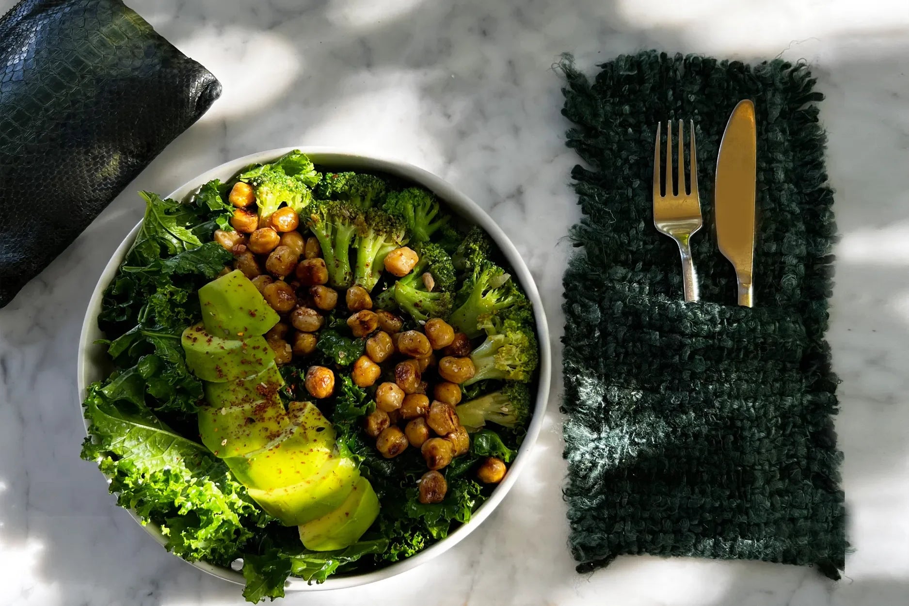 Salade saine avec avocat et pois chiches dans pochette à couverts en coton vert foncé