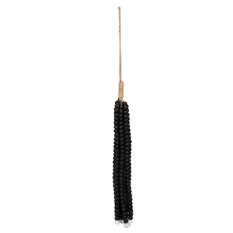 Pompon mural en perles de bois noires suspendu par cordon naturel