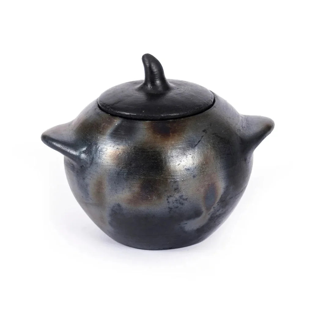 Vase en poterie noire avec couvercle et anses, Le pot brûlé