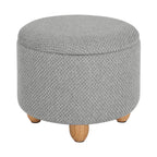 Pouf de rangement rond gris clair fermé avec pieds en pin naturel.