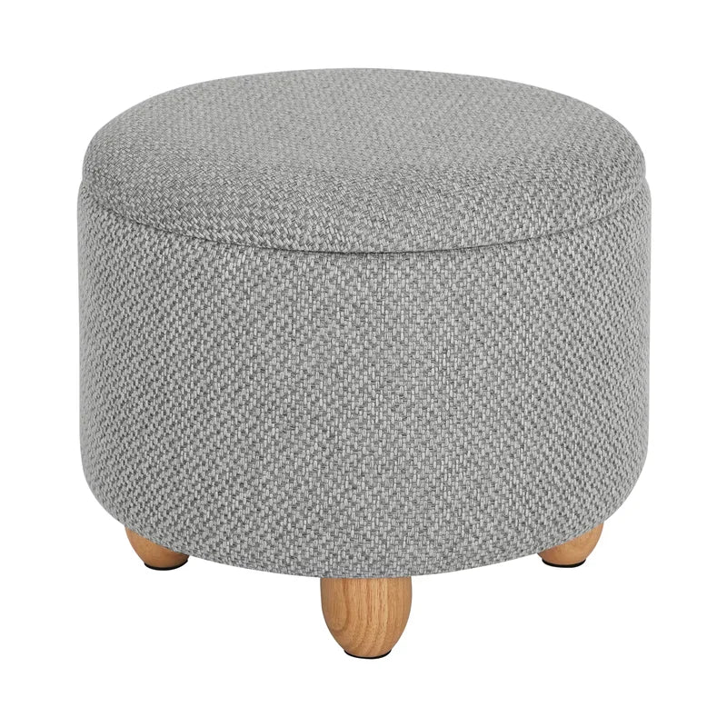 Pouf de rangement rond gris clair fermé avec pieds en pin naturel.