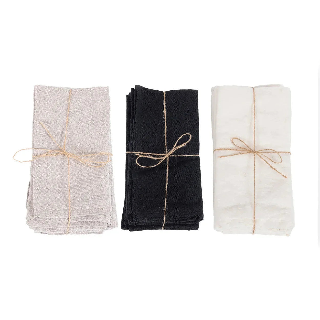 Trois paquets de serviettes en lin naturel beige, noir et blanc, liés avec de la ficelle