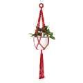 Suspension en macramé rouge à franges longues avec pot blanc et plante verte