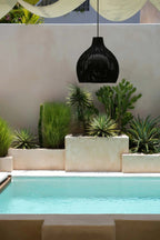 Suspension en rotin tressé noir forme goutte Ø50 cm au-dessus de la piscine