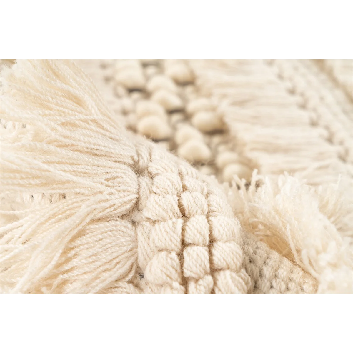 Tapis en laine écru à rayures texturées avec franges et bobbles en gros plan