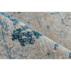 Premier plan d un tapis rectangulaire oriental bleu à effet vieilli en tissu