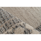 Zoom sur un tapis rectangulaire beige à motifs géométriques en tissage plat