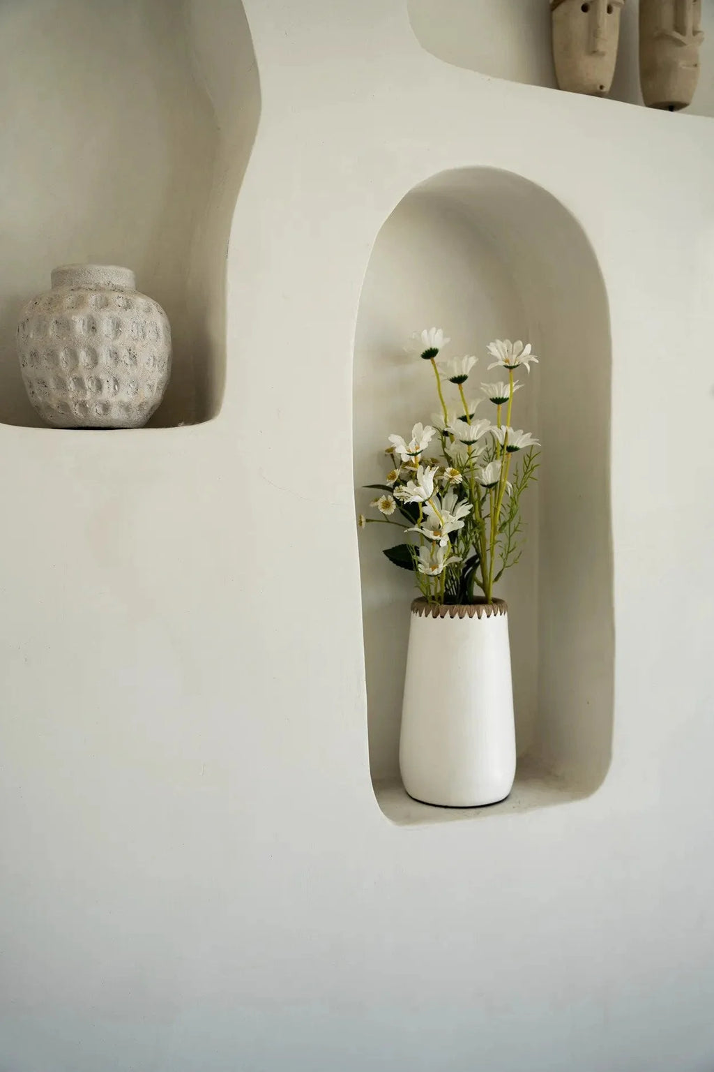 Vase en terre cuite blanc avec bord tressé en Raphia rempli de marguerites